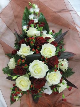 Punaisista ja valkoisista kukista sidottu hautavihko